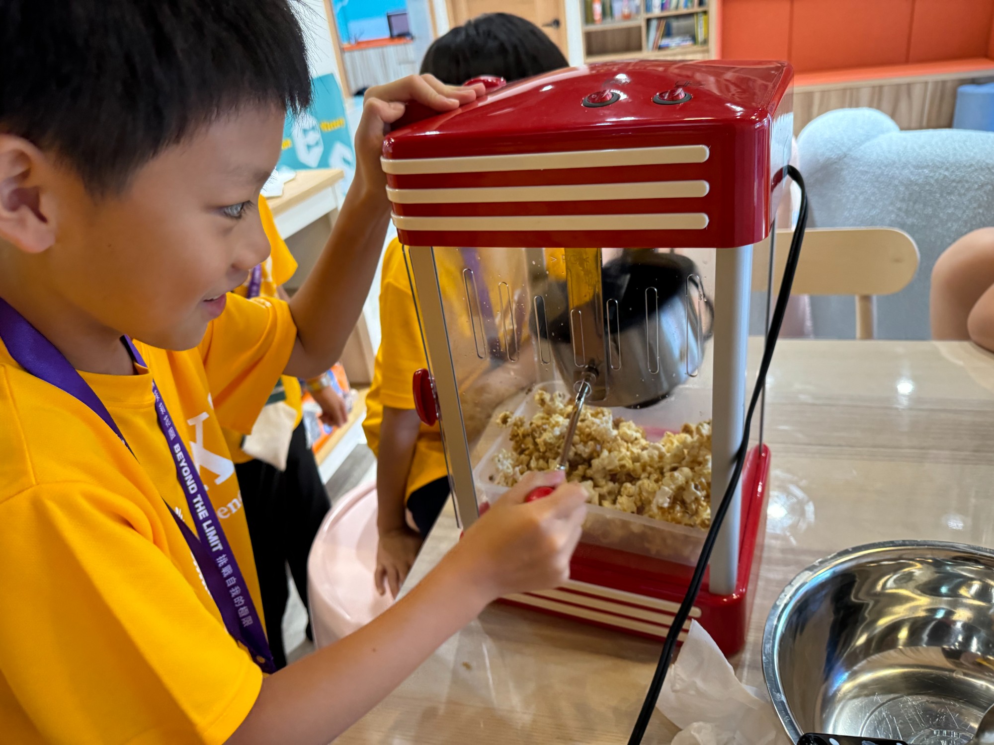 A hands-on moment with a popcorn machine.